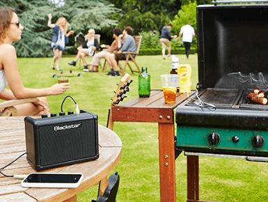 lifestyle image of Blackstar FLY connected to a phone in a gathering