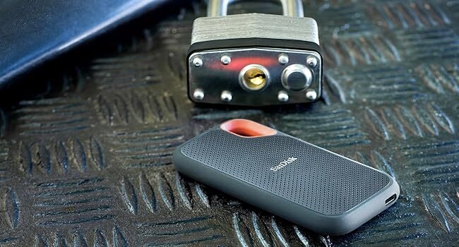 Portable SSD hanging from a hook on a backpack