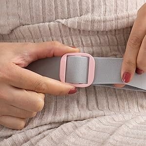 Women adjusting the belt to make the Electronic Heating Pad more tight or lose