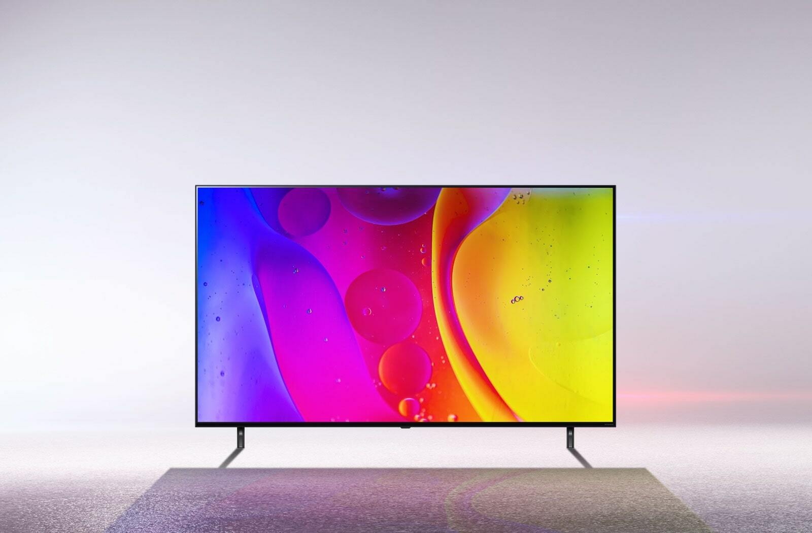 A TV in a stark white room displays bright, hypnotic moving colors on the screen.