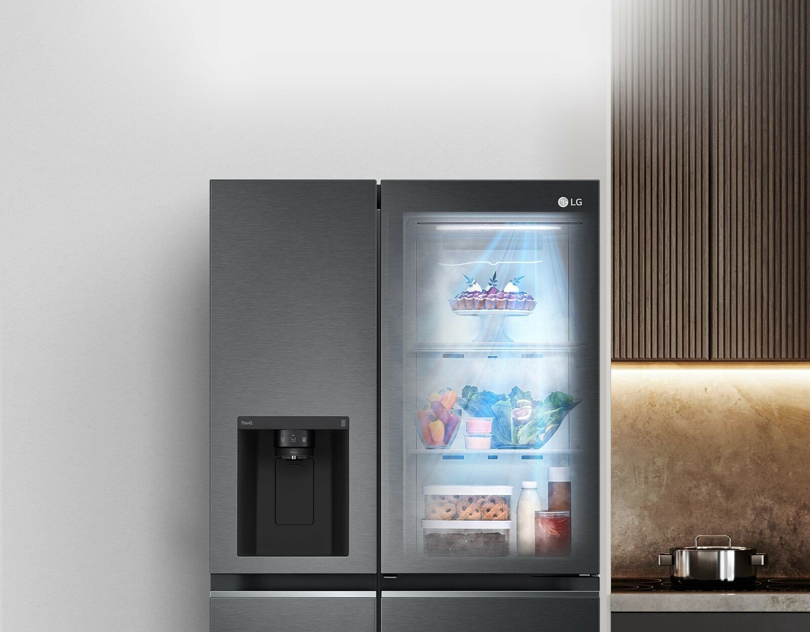 The front view of a black InstaView refrigerator with the light on inside. The contents of the refrigerator can be seen through the InstaView door. Blue rays of light shine down over the contents from the DoorCooling function.
