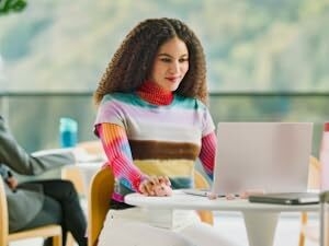 a woman using mx anywhere 3s wireless compact mouse with 8k dpi sensor and fast scrolling