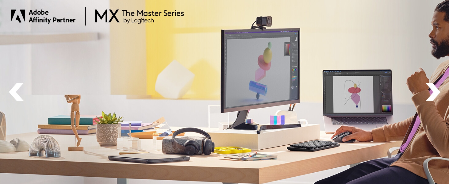 A man working on computer using mx master 3s mouse and mx mechanical mini keyboard