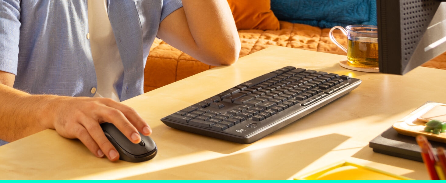 a man using mk295 wireless keyboard and mouse combo