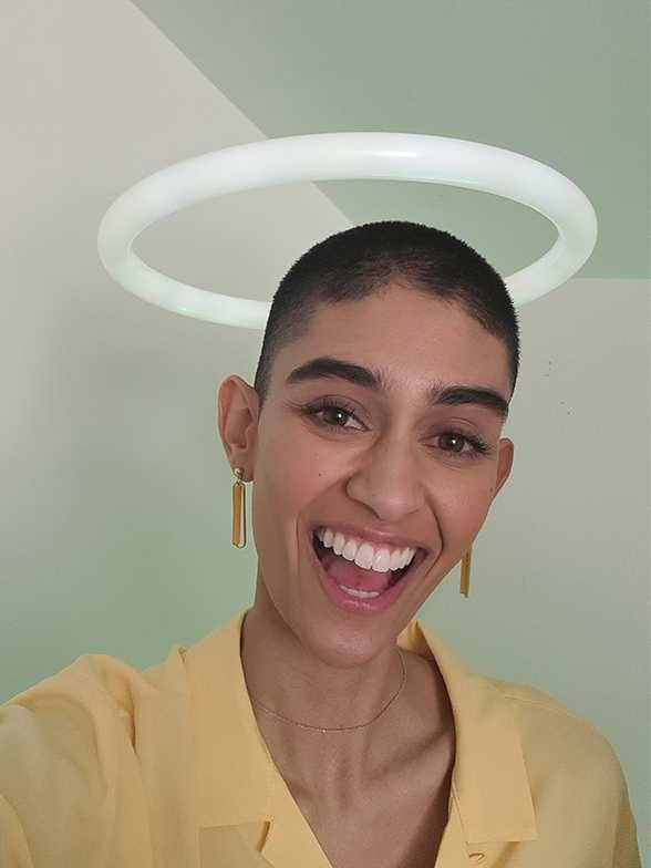 Selfie photo taken on Galaxy S20 plus of a woman underneath a circular light that looks like a halo