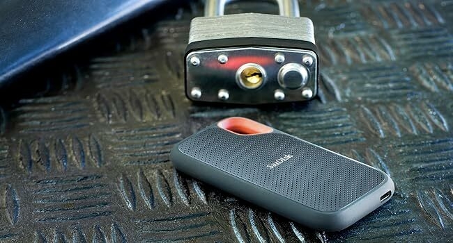 Portable SSD hanging from a hook on a backpack