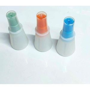 Silicone oil bottle with attached brush