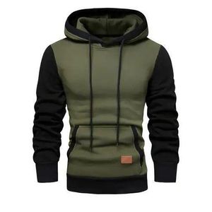 men's slim-fit colorblock pullover hoodie featuring contrast black sleeves, trim, and hood lining set against an army green body with a front kangaroo pocket and lower patch detail.