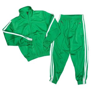 A green tracksuit with two white stripes in sizes 26 to 38